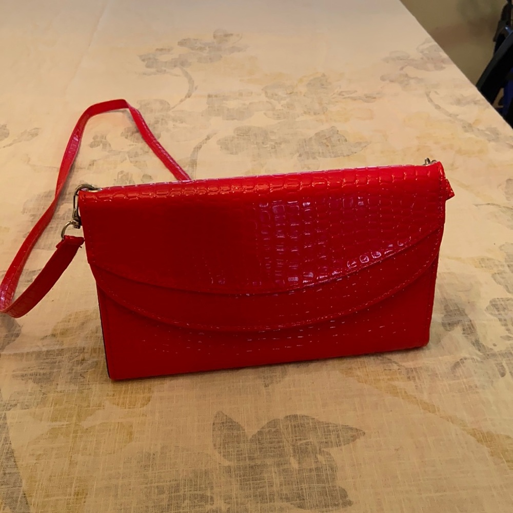 Bright red mini bag with adjustable strap. Never carried
